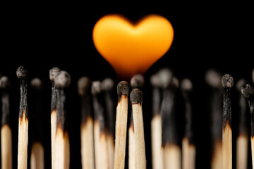 Symbol of love, devotion, passion, burning in love. Two burning matches between other burnet...