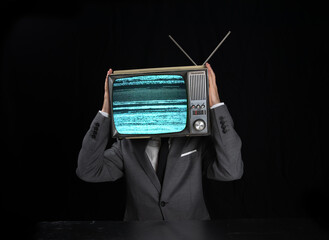 Man wearing suit with TV on head
