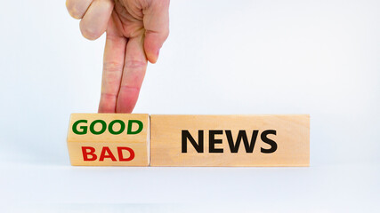 Good or bad news concept. Businessman turns a block and changes words 'bad news' to 'good news'. Beautiful white background. Business, good or bad news concept. Copy space.