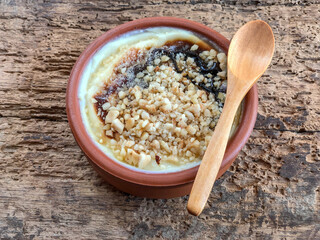 bowl of baked rice pudding that is a traditional Turkish dessert on wooden table