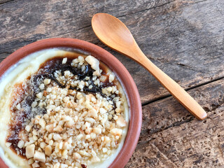 bowl of baked rice pudding that is a traditional Turkish dessert on wooden table