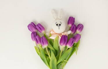 A soft toy bunny and a bouquet of tulips. Spring concept. Gift.