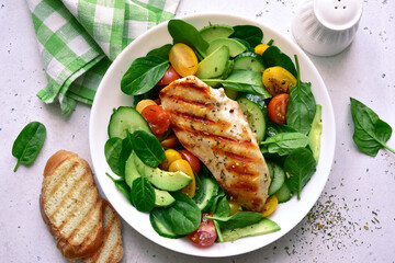 Fresh vegetable salad with grilled chicken fillet. Top view with copy space.