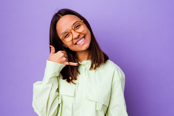 Young mixed race woman isolated showing a mobile phone call gesture with fingers.