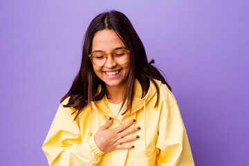 Young mixed race woman isolated laughing keeping hands on heart, concept of happiness.