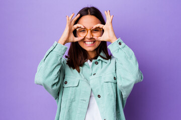 Young mixed race woman isolated excited keeping ok gesture on eye.