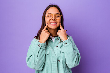 Young mixed race woman isolated doubting between two options.