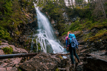 Rohacske lake in Slovakia. Western Tatras mountains, Rohace Slovakia. Woman hiker with backpack rises to the mountains. Discovery travel concept.