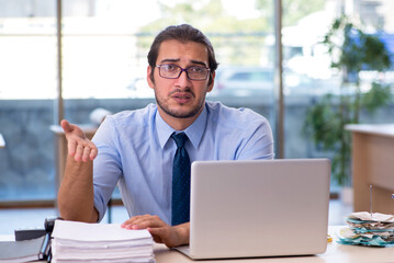 Fototapeta premium Young male accountant working in the office