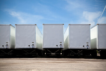 Row of transport truck trailers in a yard