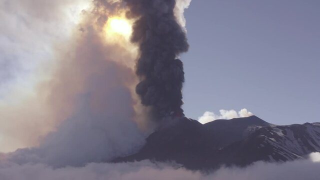 Aerial shooting with drone of the paroxysm of the Etna volcano by day 02 March 2021. Explosions, lava and column of smoke that covered the neighboring Etna villages with ash and lapilli.