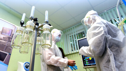 Portrait of doctors in clean suits with a protective mask and respirator.