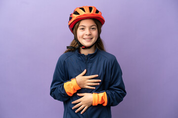 Little caucasian girl isolated on purple background smiling a lot