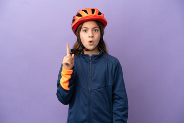 Little caucasian girl isolated on purple background intending to realizes the solution while lifting a finger up