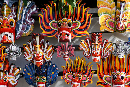 Colorful carved wood dance masks of Sri Lanka for sale at shop in Kandy