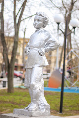 statue of a little boy in a children's park