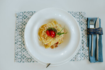 Top view of carbonara pasta with bacon, cheese and cream in restaurant.
