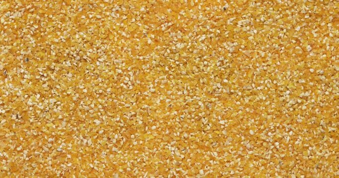 Closeup corn groats rotation, background, texture. Slow motion 50fps, zoom effect. Food background.
