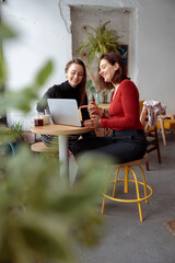 Young happy beautiful caucasian woman in cozy modern cafe
