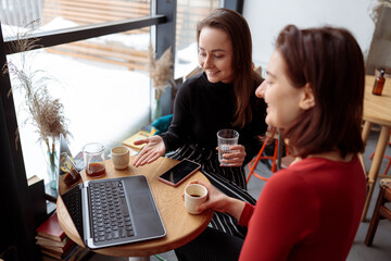 Young happy beautiful caucasian woman in cozy modern cafe