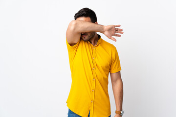 Young handsome man over isolated background covering eyes by hands