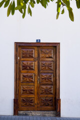 brown door of a white house