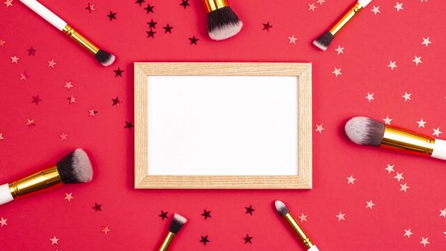 Stop motion animation mockup wooden picture frame top view of cosmetics brushes set for makeup and stars on red background. Cosmetics and beauty concept template Make up concept copy space flat lay
