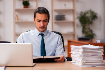 Young male employee unhappy with excessive work