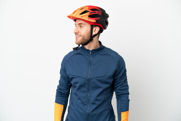 Young cyclist man isolated on white background looking side