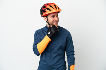 Young cyclist man isolated on white background looking to the side and smiling