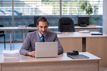 Young male employee working in the office