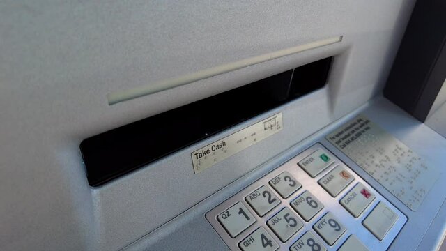 Close up shot of taking money of an ATM Machine