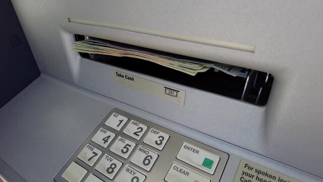 Close up shot of taking money of an ATM Machine