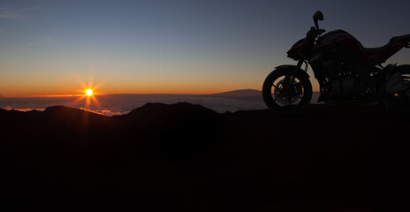 Motorbike parking with sunset background. Biker ride motorcycle. Silhouette of motobike. Trip and lifestyle motorbike Concept.