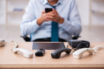 Young male call center operator working at his desk