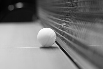 table tennis ball on the table next to the net