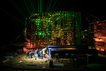 Stylized photo of an electronic microcircuit. Microcircuit, contacts, electronics, motherboard. Black background. Macro photography of electronic devices.