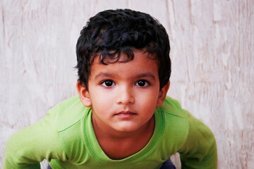 Obraz premium three year old indian baby boy in close up looking with green t shirt