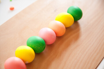 Easter pattern of Eggs with flowers and candies on the white background. Easter concept. Healthy feeding concept.