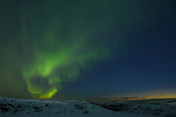 Obraz na płótnie Canvas Northern lights in the sky. Snowy tundra at night.