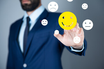 man holding smiling face icons