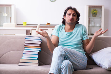 Young male student unhappy with excessive work at home