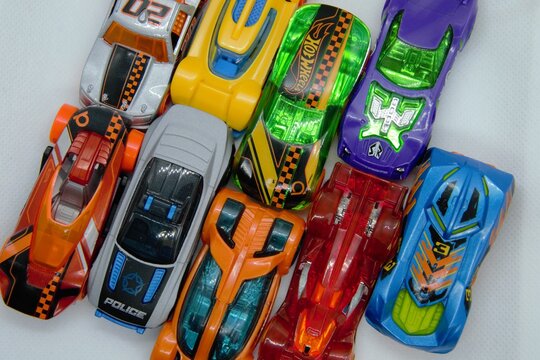 Mix of miniature, colorful toy cars. A lot of little toy car models, ready for play. Toy cars background, top view. Warsaw, Poland - March 3 2021