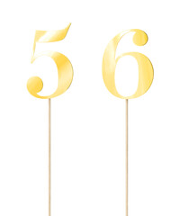 Shiny gold  topper paper cake numbers signs (five, six) on stick isolated on white background....