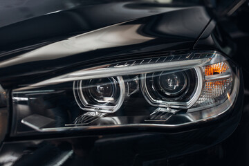 Obraz na płótnie Canvas The headlight of modern luxury car. Close up detail shot
