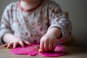 A child picking up kiwi fruit