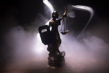 Law concept. Miniature colorful artwork decoration with fog and backlight. The Statue of Justice -...