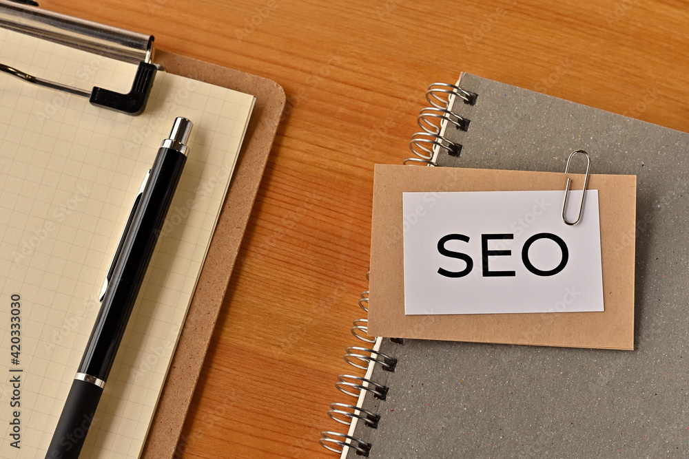 Poster there is a piece of paper with the word seo written on it. it was an abbreviation for search engine 