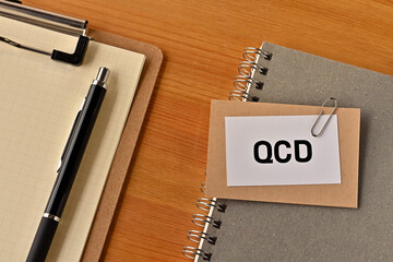 There is a piece of paper with the word QCD written on it. It was an abbreviation for Quality, Cost, Delivery.