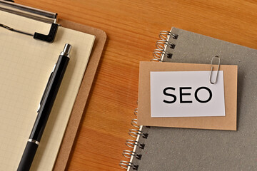 There is a piece of paper with the word SEO written on it. It was an abbreviation for Search Engine Optimization.